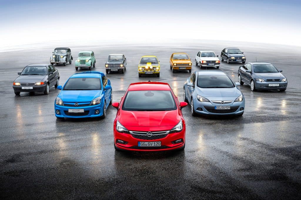 Familientreffen: hinten sämtliche Opel Kadett-Generationen, vorn alle Astra – angeführt vom jüngsten Modell, dem Auto des Jahres 2016